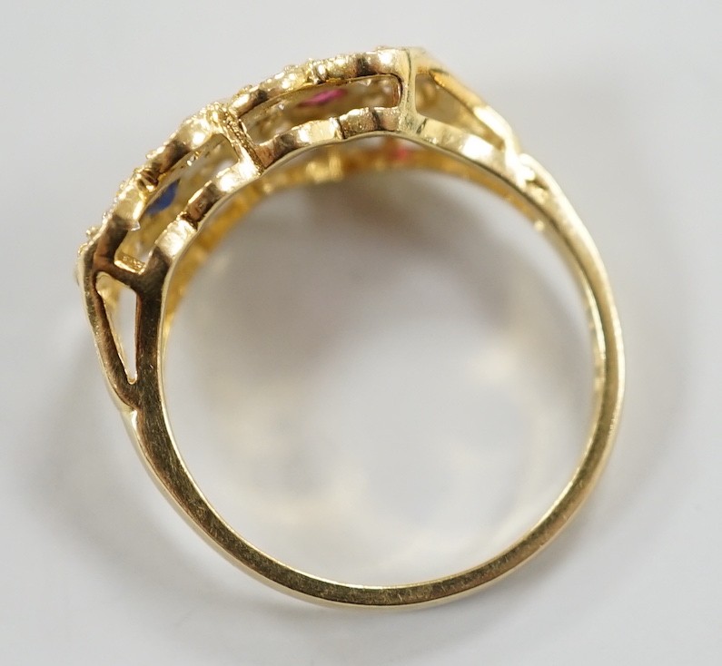 A modern 18ct gold, ruby, sapphire and diamond set twin heart cluster ring, size M, gross weight 4 grams.